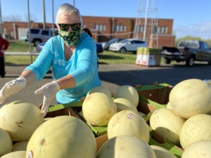 Woman with melons at distribution