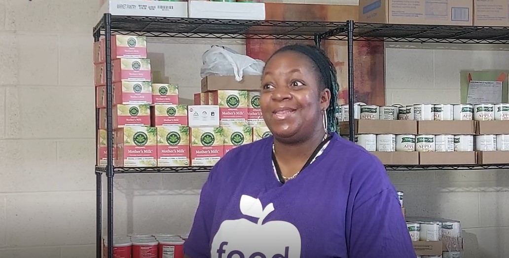Jakia Harvey is the Food Pantry Manager at Destiny Christian Fellowship. She wears a purple shirt and speaks to someone off camera.